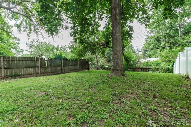 View of fenced backyard | Image 16