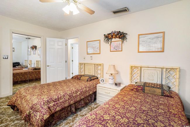 Bedroom featuring carpet flooring, ceiling fan, and a closet | Image 22