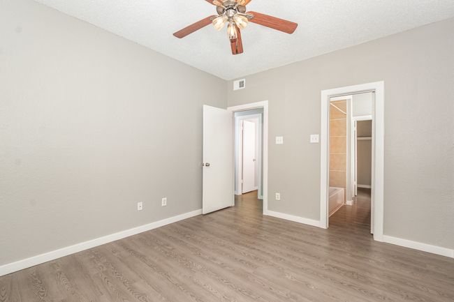 Unfurnished bedroom with light wood-style floors, baseboards, and a ceiling fan | Image 16