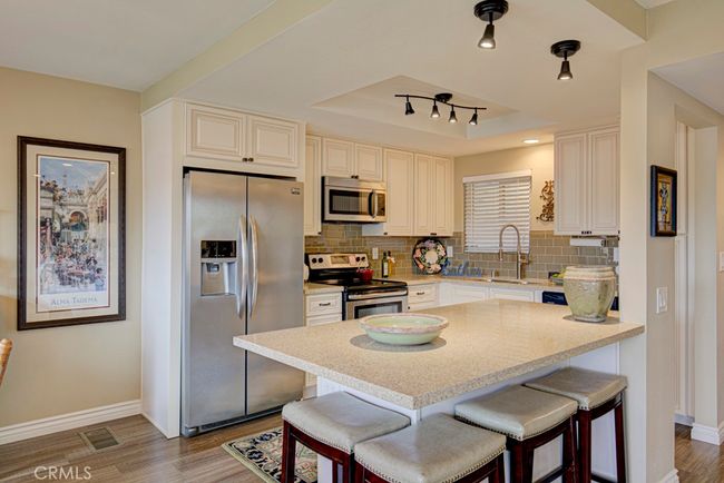 Kitchen island offers breakfast bar seating for up to four. | Image 15