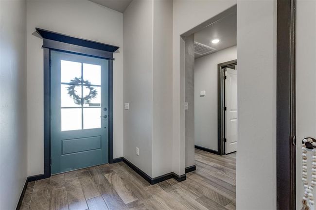 Entryway with light wood-type flooring, visible vents, and baseboards | Image 43