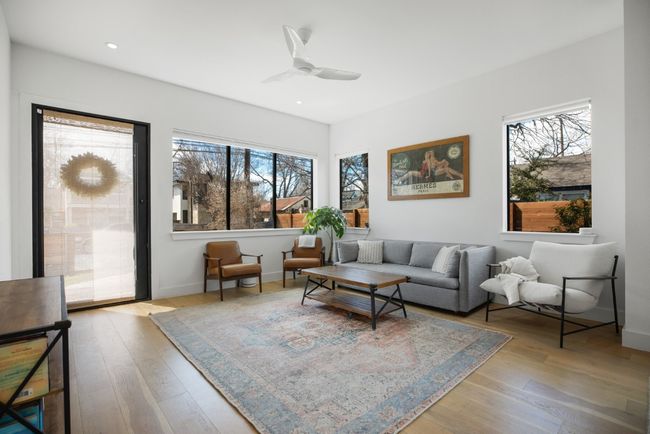 Living room featuring a ceiling fan, baseboards, wood finished floors, and recessed lighting | Image 5