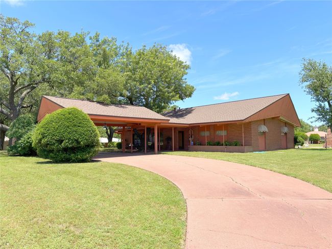 View of front of property featuring concrete driveway, a front lawn, roof with shingles, and an attached​​‌​​​​‌​​‌‌​‌‌​​​‌‌​​‌‌​‌​​​​​‌ carport | Image 4