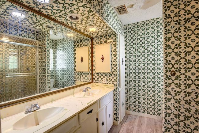 Bathroom featuring wallpapered walls, double vanity, a textured ceiling, toilet, and a shower stall | Image 12