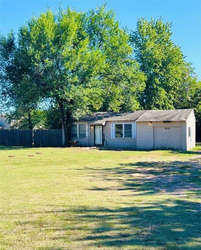 Single story home featuring a garage and a front yard | Image 1