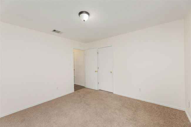 Unfurnished bedroom with baseboards, visible vents, and light carpet | Image 10