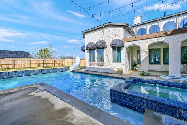 View of pool featuring an in ground hot tub and a water slide | Image 34