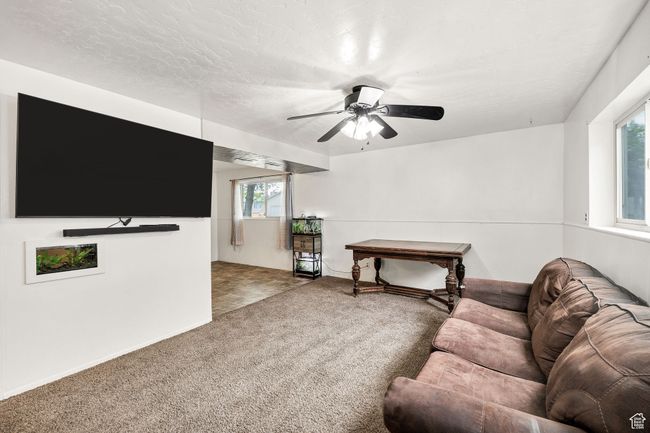 Carpeted living area with ceiling fan | Image 21