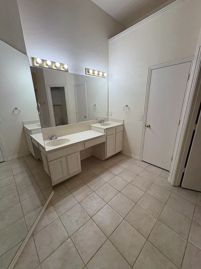 Bathroom with tile patterned flooring and double vanity | Image 14