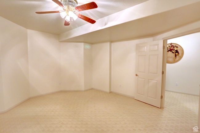 Empty room with light colored carpet, baseboards, and ceiling fan | Image 43