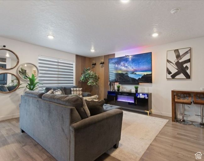 Living room featuring wood finished floors, baseboards, recessed lighting, and a textured ceiling | Image 5