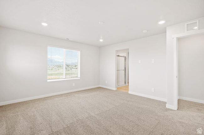 Unfurnished bedroom featuring light carpet, baseboards, and recessed lighting | Image 29
