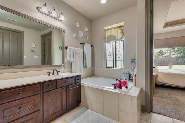 Bathroom featuring vanity, a garden tub, ensuite bath, tile patterned floors, and recessed lighting | Image 29