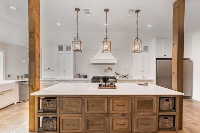 Kitchen featuring refrigerator, stainless steel dishwasher, open shelves, backsplash, and white cabinets | Image 10
