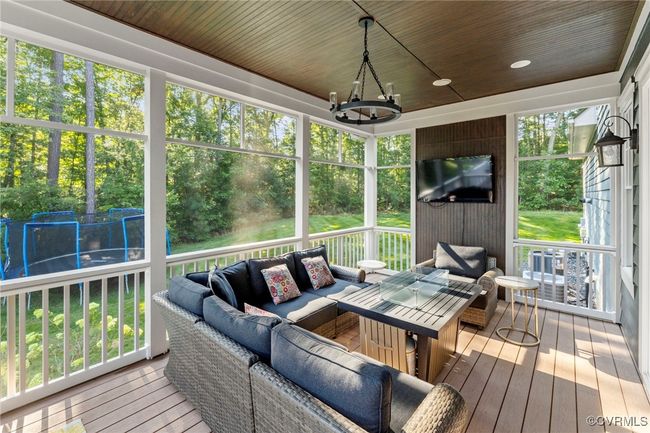 Sunroom featuring an outdoor living space, a chandelier, and ceiling fan | Image 42
