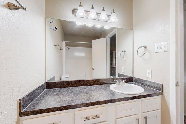 Full bath with vanity and a textured wall | Image 32