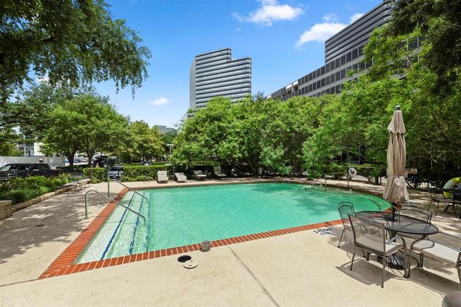 Community pool with stunning curb appeal. A lot of trees for added shades. | Image 14