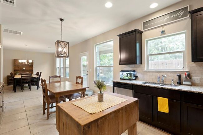Open concept kitchen allows view of breakfast area and dining area. | Image 8