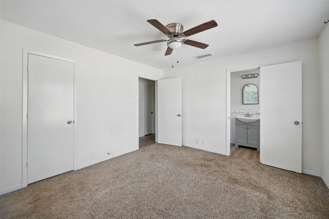 Unfurnished bedroom with a sink, carpet floors, ensuite bath, baseboards, and a ceiling fan | Image 6