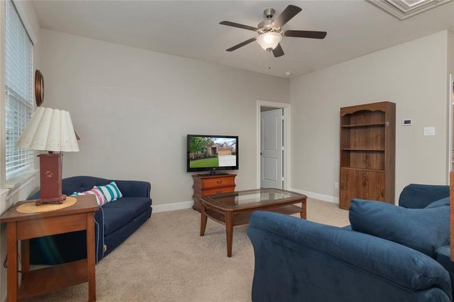 Cozy game room with plush carpet and neutral wall colors create a comfortable and inviting space. | Image 34