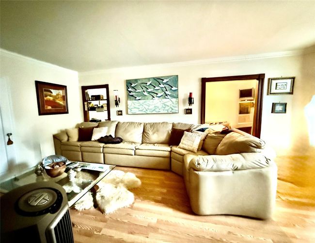 Living room featuring crown molding and wood finished floors | Image 6