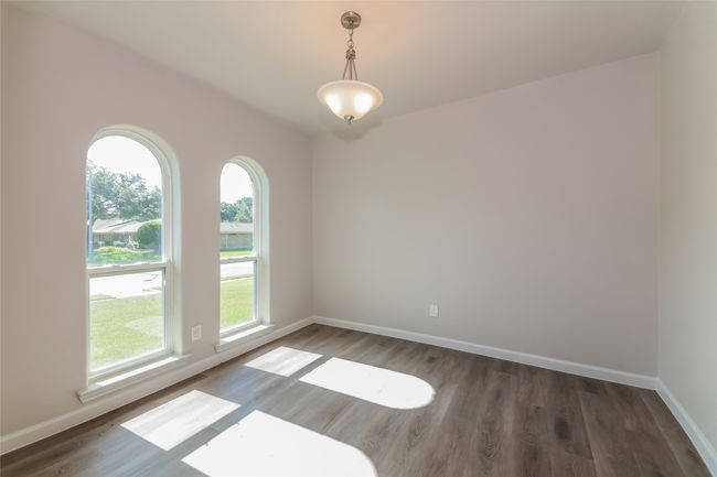 Spare room featuring wood finished floors and baseboards | Image 8
