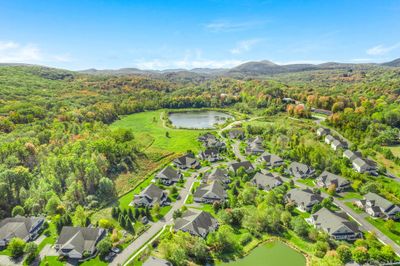 Drone / aerial view featuring a water and mountain view | Image 2