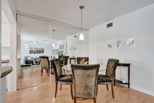 Dining Area with slider mirrors that provide plenty of storage. | Image 10