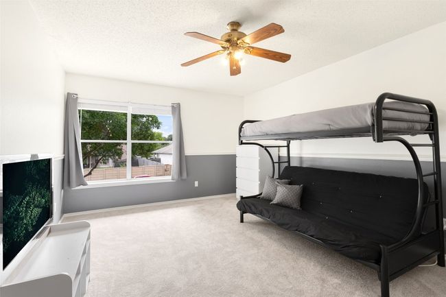 Discover your perfect retreat in this beautifully updated bedroom with new paint and cozy carpet. Enjoy the gentle ceiling fan breeze and a stunning view of a majestic oak tree. Ideal for relaxation after a long day! | Image 25
