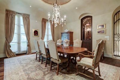 Formal dining room has Walnut Floors, custom drapes are Scalamandre and Conrad Shades, rock crystal chandelier. Wine Cellar and Butler's Pantry are next to the dining room. | Image 3