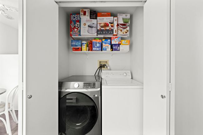 Clothes washing area featuring washer and dryer and laundry area | Image 8