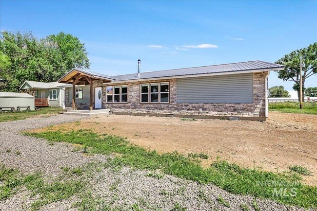 View of front of house featuring a metal roof, a porch, and crawl space | Image 27