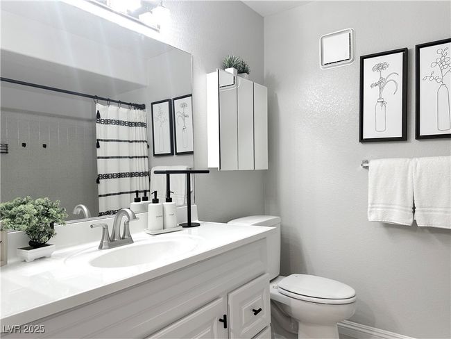 Bathroom with vanity, toilet, curtained shower, and baseboards | Image 22