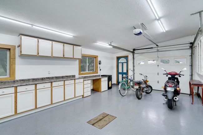 This is the 3rd attached stall that has a handy drain and lots of built-in storage and additional shop space. | Image 37