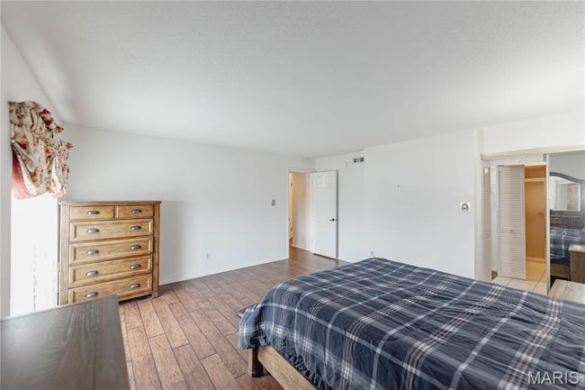Bedroom featuring wood-type flooring and baseboards | Image 32