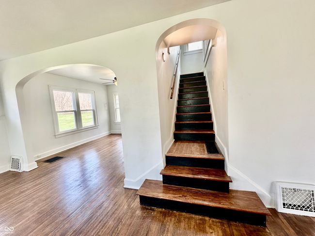 stairs with visible vents, ceiling fan, and wood finished floors | Image 27