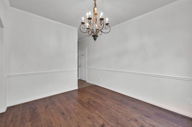 The dining room is just off the foyer, perfect for welcoming your dinner guests. | Image 9