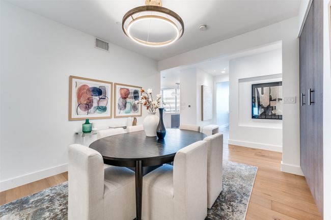 Dining room featuring light wood finished floors, baseboards, and a chandelier | Image 17