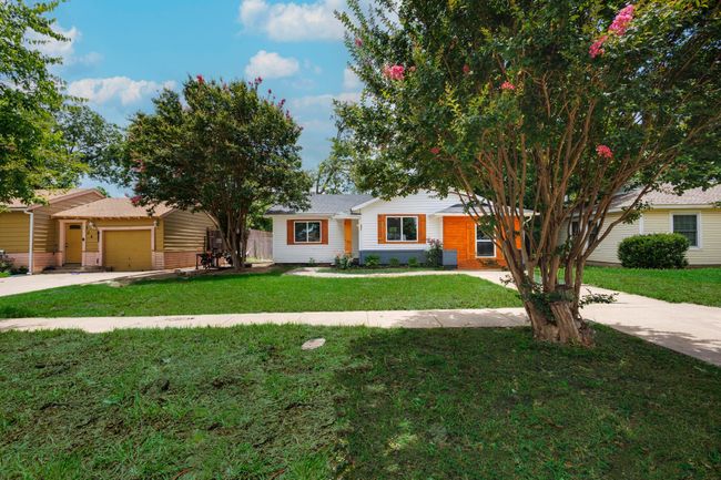 View of front of property featuring driveway, a front yard, and an attached garage | Image 13