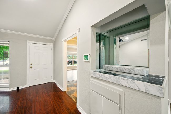 This stylish dry bar area offers the perfect spot for entertaining, with built-in shelving and cabinetry that adds both charm and functionality. | Image 7