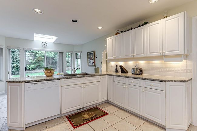 Kitchen with a peninsula, a skylight, a sink, dishwasher, and tasteful backsplash | Image 10