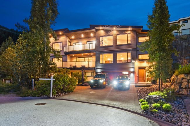 Contemporary home featuring decorative driveway, a garage, and a balcony | Image 39