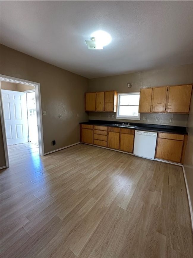 Kitchen view from the hallway with the door (to storage area and backyard) opened. | Image 36
