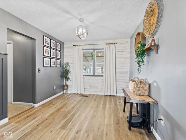 foyer entrance with baseboards, a textured ceiling, and light wood-type flooring | Image 16