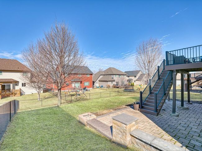 Stairs lead to a beautiful paver patio and a flat lot, perfect for lawn games, parties, and more! | Image 29