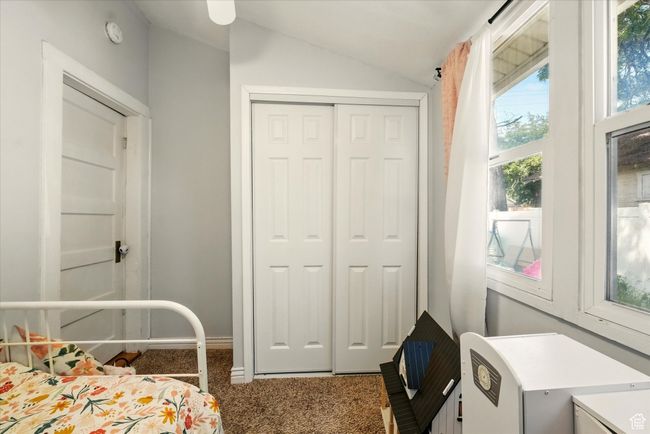 Carpeted bedroom with lofted ceiling and a closet | Image 16