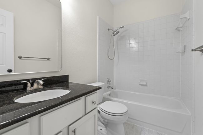 Hall bath has updated mirror and fixtures. | Image 19
