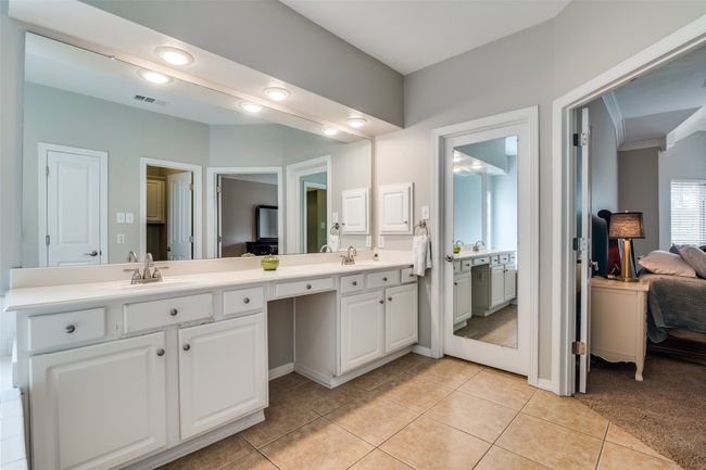 The primary bathroom has dual sinks and a walk in closet. Make sure you look great before heading out of the house with all the mirrors. | Image 18