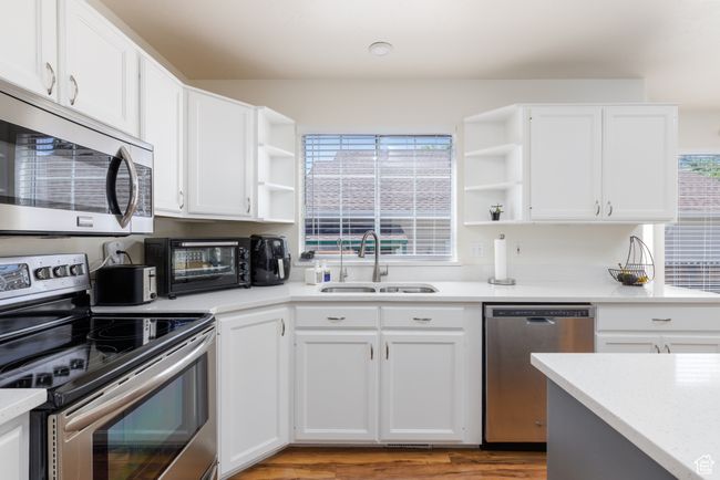 Kitchen with open shelves, appliances with stainless steel finishes, a sink, and healthy amount of natural light | Image 6