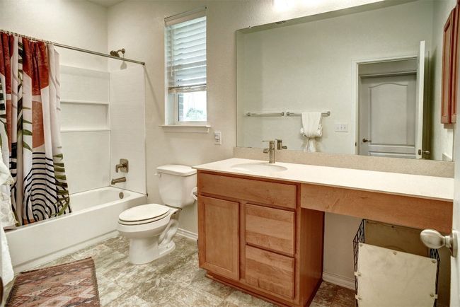 Guest Bathroom with shower / bath combination with curtain and vanity | Image 8